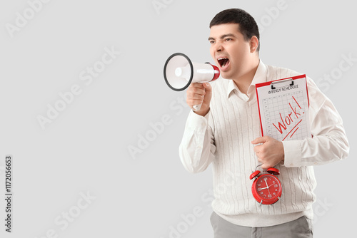 Young man with alarm clock ...