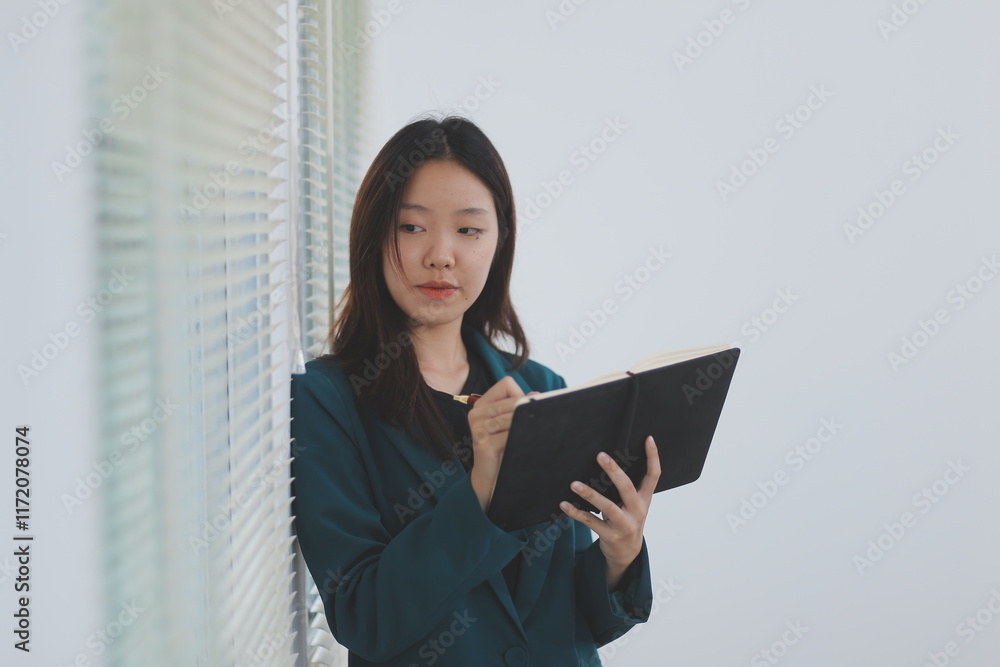 business woman working with laptop while consulting some invoice and document in working space at home business woman working with laptop while consulting some invoice and document in working space at home