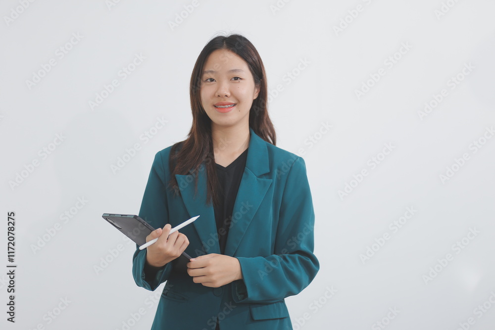 Attractive elegant young asian business woman using digital tablet standing on isolated background. Happy young latin female formal black suit holding tablet gadget working service with customer Attractive elegant young asian business woman using digital tablet standing on isolated background. Happy young latin female formal black suit holding tablet gadget working service with customer