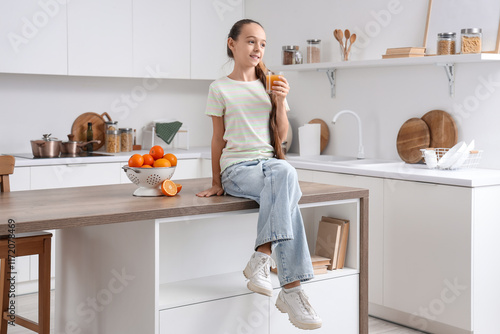 Teenage girl with orange ju...