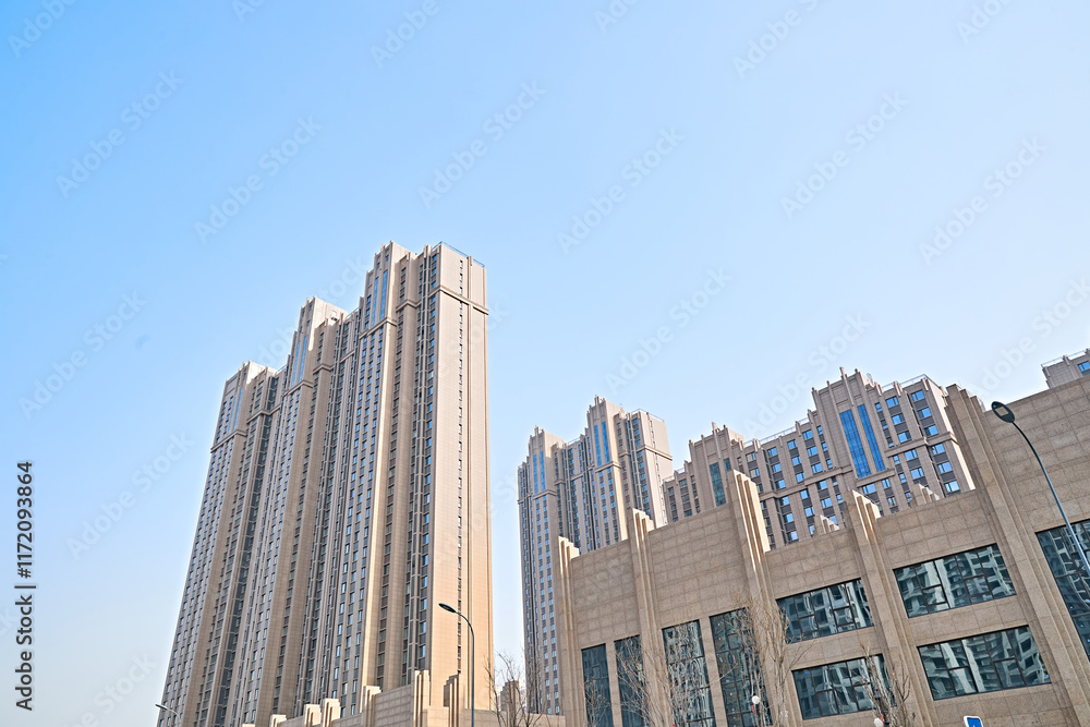 Fototapeta premium Looking up at modern office buildings and local landscape