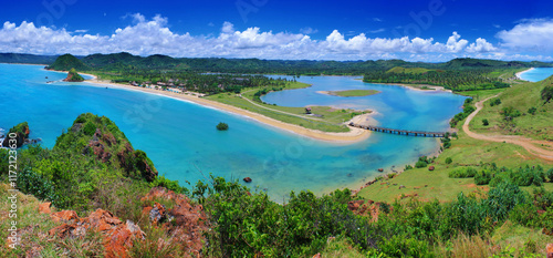Seger beach with a bridge in the middle of the beach seen from the top of the hill at Seger Beach Lombok Indonesia