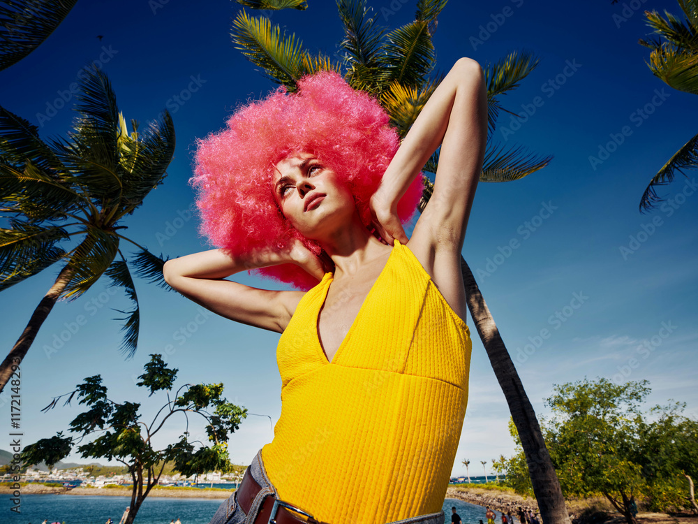 © SHOTPRIME STUDIO - Pinkhaired woman posing in front of palm trees on a hawaiian beach, with clear skies and ocean in the background, capturing a vibrant and tropical vacation vibe © SHOTPRIME STUDIO - Pinkhaired woman posing in front of palm trees on a hawaiian beach, with clear skies and ocean in the background, capturing a vibrant and tropical vacation vibe