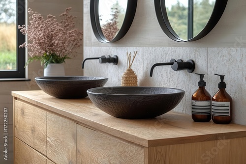 luxurious ensuite bathroom featuring wallmounted timber vanity black sink and pillshaped mirrors showcasing elegance and modern design in a hotel setting photo