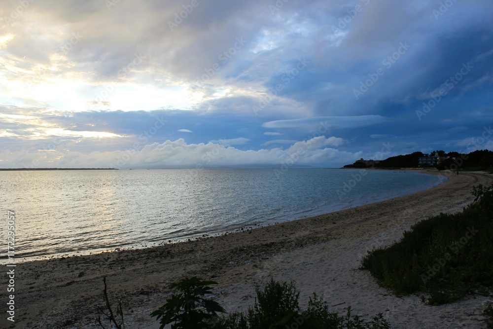 Sunset at the beach of a tropical island's cloudy evening Sunset at the beach of a tropical island's cloudy evening