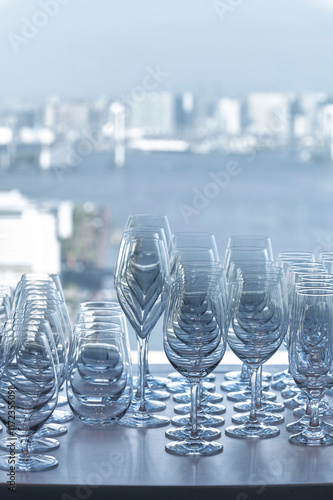 Obraz na płótnie Wine and Drink glasses are arranged in front of drinks counter bar with cityscape background w salonie