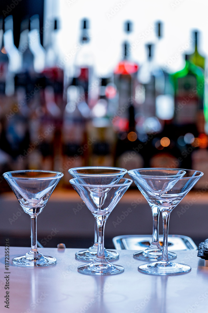 Wine and Drink glasses are arranged in front of drinks counter bar with cityscape background