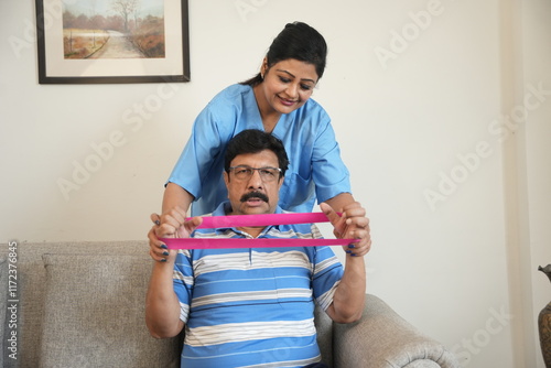 Indian female physiotherapist, stretching band and mature patient, medical care and wellness. Orthopedic,healthcare and chiropractor with person for physical therapy, rehabilitation and exercise photo