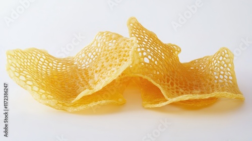 crispy cheese flavored net chips stacked creatively on a white background photo