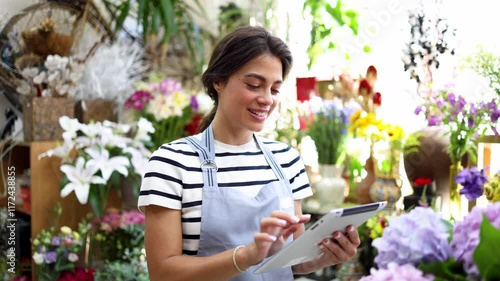 Portrait of a beautiful, happy woman running a flower shop