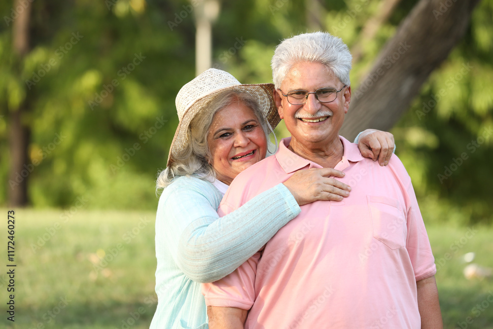 Indian happy senior beautiful couple embracing tohether and looking romantic and close together in garden Indian happy senior beautiful couple embracing tohether and looking romantic and close together in garden