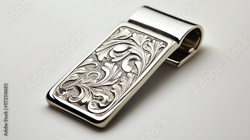 Elegant silver money clip with intricate floral engraving on a white isolate background. photo