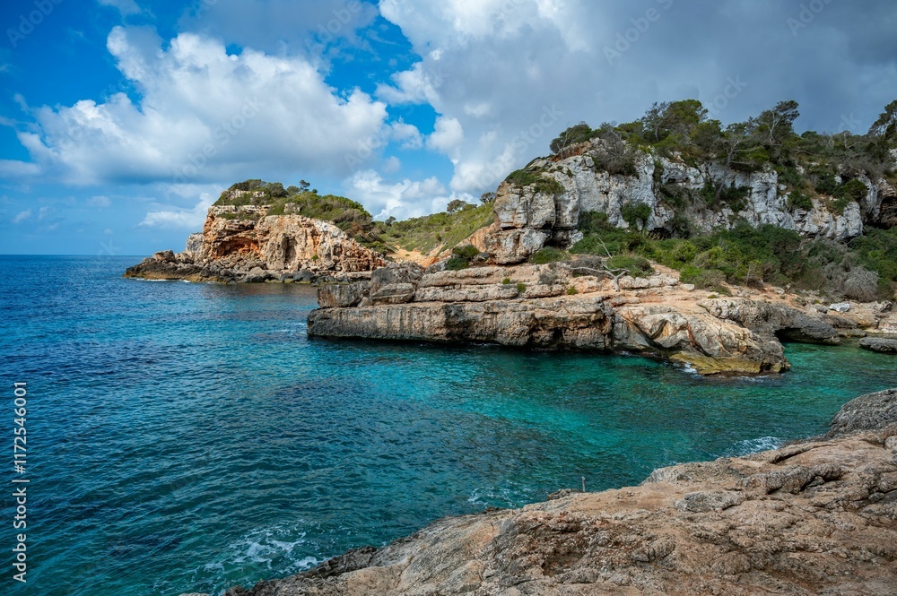 Rocky coastal landscape with turquoise water and clouds Rocky coastal landscape with turquoise water and clouds