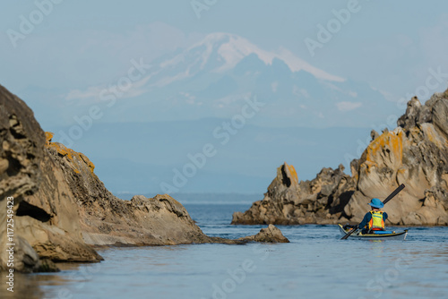 Wallpaper Mural Woman kayaking along Sucia Island in the San Juan Islands in the Pacific Northwest in Washington with Mt Baker in background Torontodigital.ca