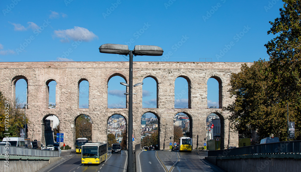 Traffic in Ataturk boulevard with view of Valens Aqueduct in background. Cloudy autumn view.