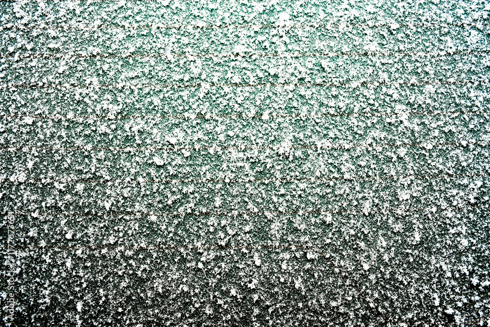 Texture of ice and frost covering a glass surface. Large and mineral crystals create a complex pattern that emphasizes the frosty atmosphere. Texture of ice and frost covering a glass surface. Large and mineral crystals create a complex pattern that emphasizes the frosty atmosphere.