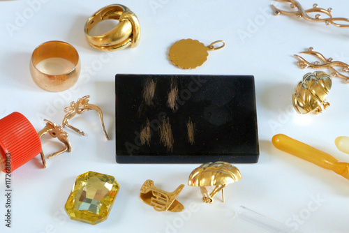 Принти на полотні A pawn shop employee tests old gold jewelry using reagents and a touchstone, Buy