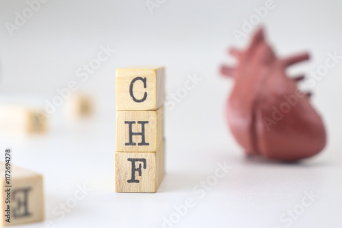 Congestive Heart Failure acronym. CHF word written on wooden cubes isolated with heart on white background with copy space. Concept of cardiology disease
 photo