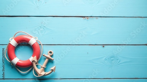 Summertime nautical scene with life preserver and anchor on blue wood
