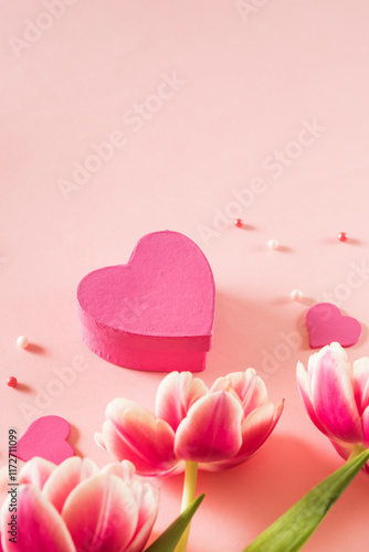 Pink tulips and hearts on a light pink background