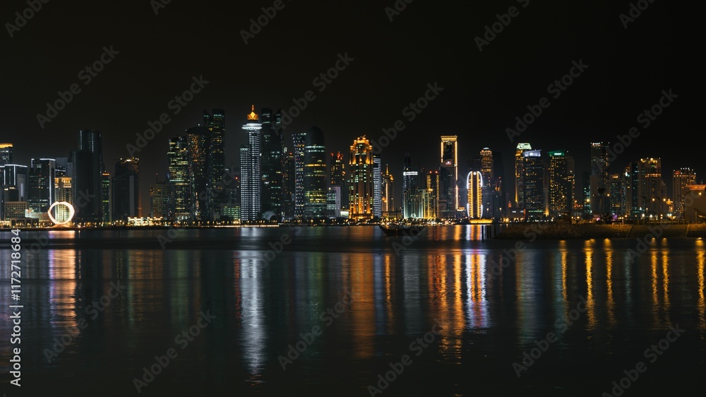 Doha skyline at night with reflections on water. Doha skyline at night with reflections on water.