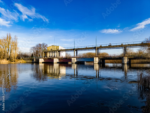 A bridge over a body of water with a building in the background