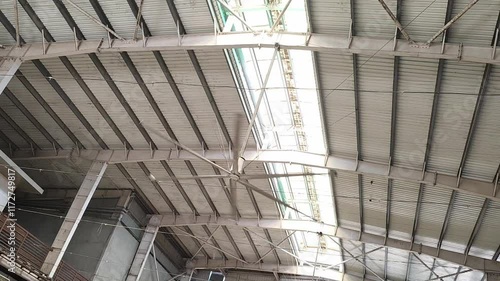 HVLS big fan on ceiling under the old metal curve roof structure of temple building, low angle view of big hvls fan. HVLS  fan on ceiling.