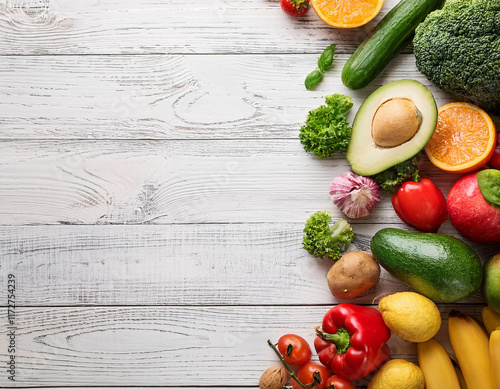 Healthy food background. Food photography different fruits and vegetables on white wooden ta photo