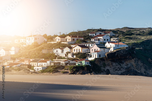 Beatiful Portuguese Colourful Traditional Houses on a Cliff at Monte Clerigo beach on the western coastline of the Algarve, near Aljezur in Costa Vicentina, Portugal, Europe.