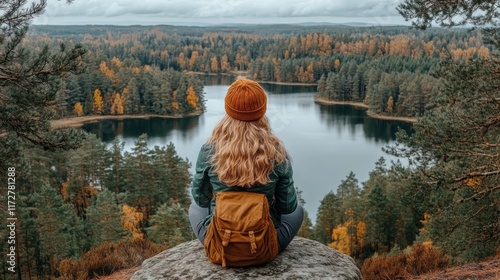 Woman hiker enjoys autumn lake view.