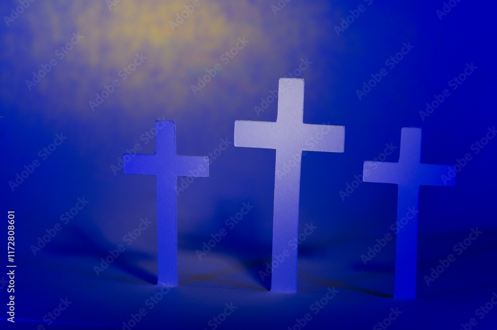 Obraz premium Three crosses with highlight on center cross on a yellow blue background