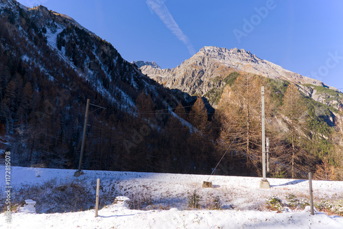 Scenic landscape at Swiss mountain pass Albula with snow and track of narrow gauge railway on a sunny autumn day. Photo taken November 15th, 2024, Albula mountain pass, Switzerland. photo