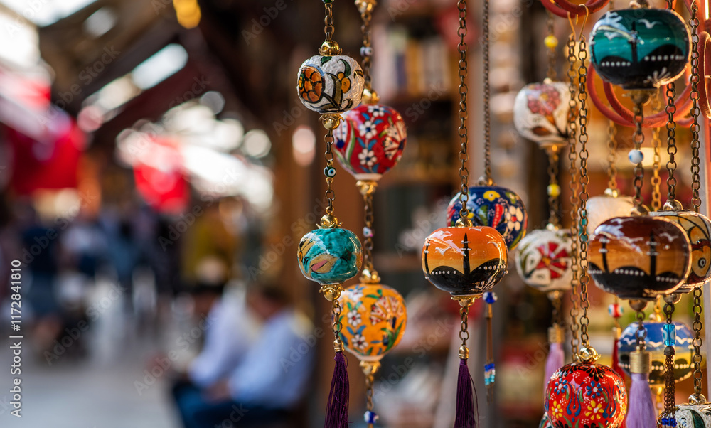 Naklejka premium beautifully painted hanging decorations against the blurred background of the market create a sense of depth and demonstrate the lively atmosphere of the market