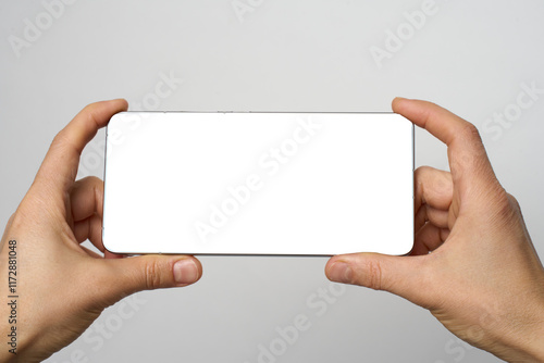 Wallpaper Mural Hand with phone on white background with copy space. Woman holding smartphone with white screen. Hand with blank cellphone display, close-up Torontodigital.ca