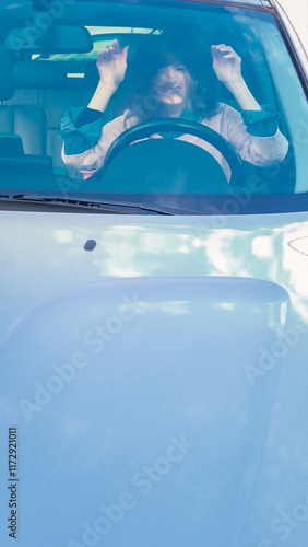 Frustrated businesswoman stuck in traffic, expressing anger while driving