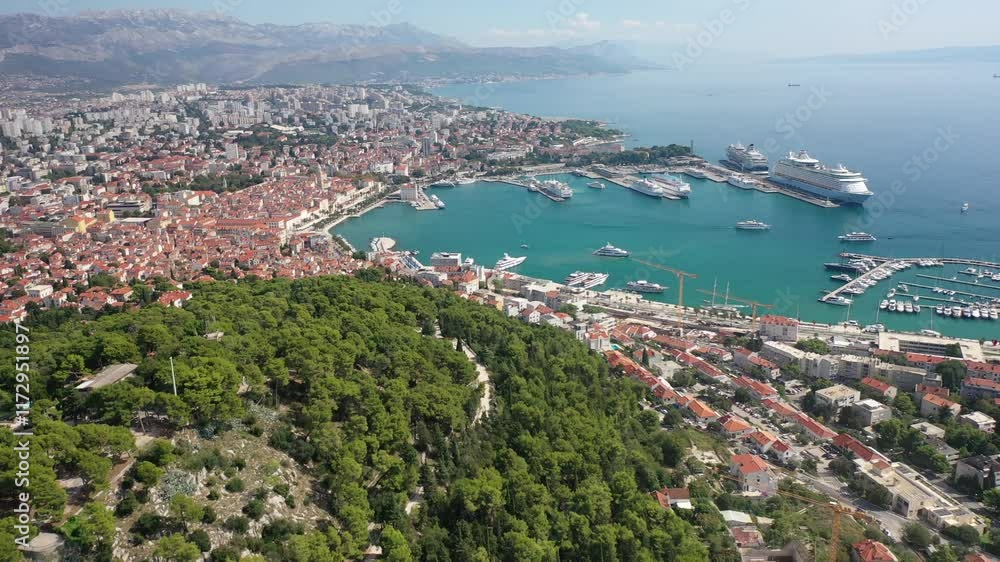 A breathtaking aerial view from Marjan Hill overlooking Split Harbor filled with ferries, cruisers, and boats. The sunlit Adriatic waters enhance the beauty of the Dalmatian coastline. A breathtaking aerial view from Marjan Hill overlooking Split Harbor filled with ferries, cruisers, and boats. The sunlit Adriatic waters enhance the beauty of the Dalmatian coastline.