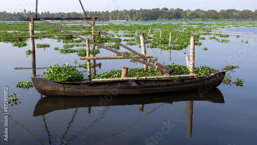 Traditional wooden boat parked in Vembanad lake at Thannermukkam, Kuttanad, Kerala, India photo