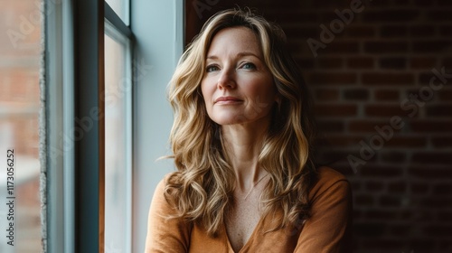 A professional woman with a focused look, standing near a window with soft natural lighting streaming in, reflecting determination Free Download A professional woman with a focused look, standing near a window with soft natural lighting streaming in, reflecting determination - GFXLoad