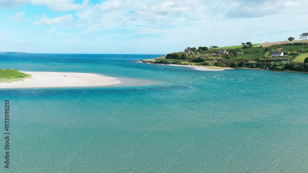 Tranquil coastal view features blue waters meeting sandy shores and vibrant green hills under a bright sky. A peaceful atmosphere perfect for relaxation and exploration. Tranquil coastal view features blue waters meeting sandy shores and vibrant green hills under a bright sky. A peaceful atmosphere perfect for relaxation and exploration.