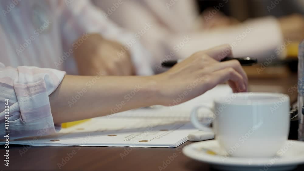 Close up hands of a businesswoman pressing the buttons on a calculator while calculating figures during a meeting, Business workshop concept Close up hands of a businesswoman pressing the buttons on a calculator while calculating figures during a meeting, Business workshop concept