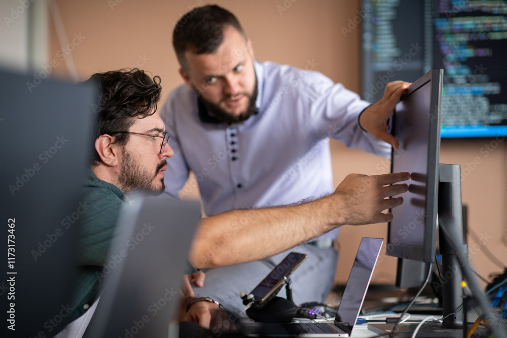 Programmers engrossed in deep collaboration, diligently working together to solve complex problems Programmers engrossed in deep collaboration, diligently working together to solve complex problems