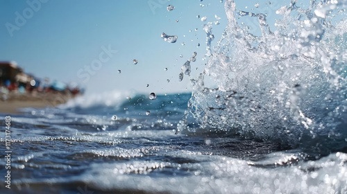 Waves abstract background idea. A close-up view of ocean waves splashing against a shore under clear blue skies.