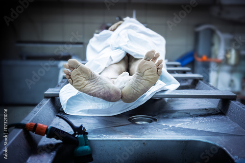 Fotografie A dead body lays on a table after an autopsy inside a morgue.