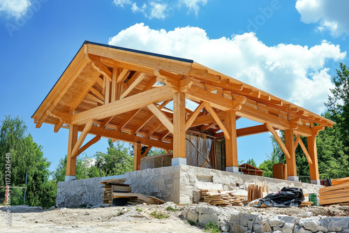 Wallpaper Mural Modern timber cabin structure rises under a clear blue sky amidst construction activity and building materials Torontodigital.ca