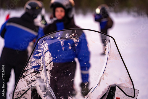 Snowmobile expedition Aurora Northern Lights in Lapland Inari Nellin Lake forest photo