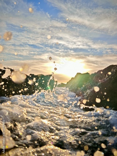Water splash on the rocks during sunrise