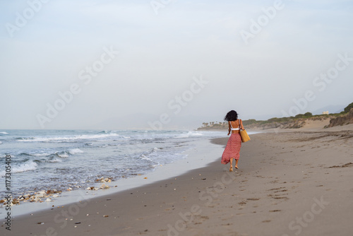 Woman Walking Barefoot on the Beach