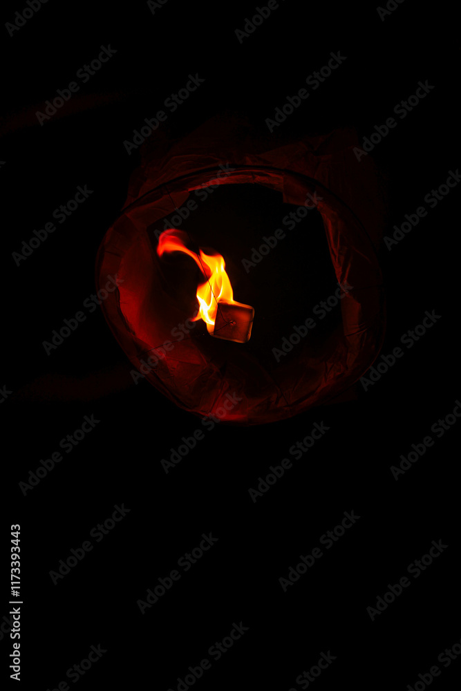 Fototapeta premium burning candle on black