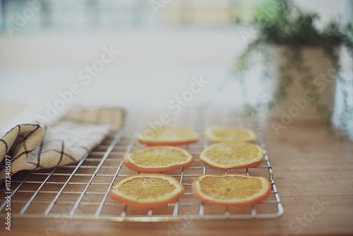 Dried orange slices on a metal cooling rack on a kitchen worktop photo