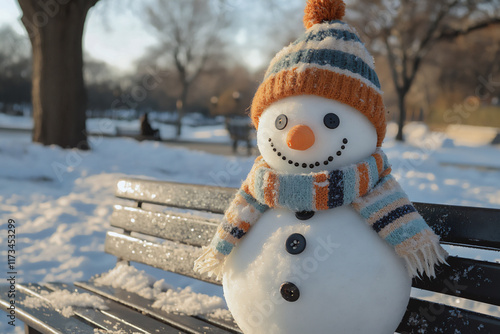  adorable snowman, carrot nose, button eyes, striped scarf, snowy bench photo